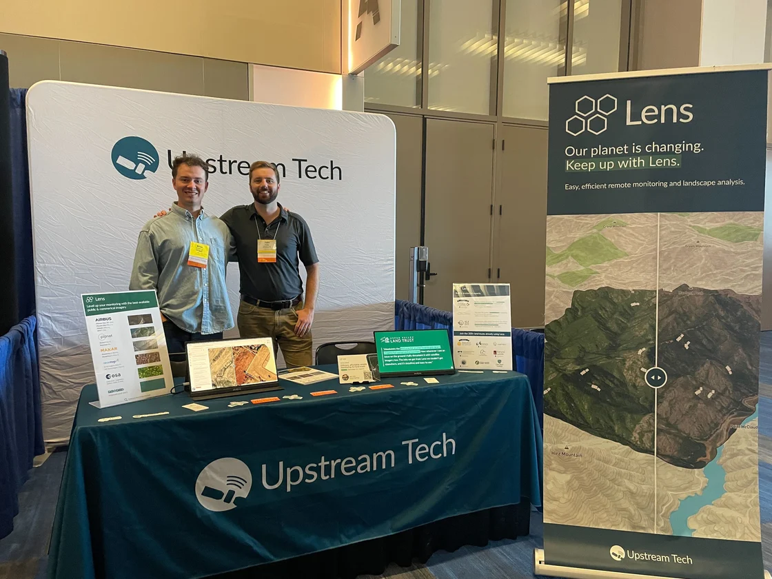 The Lens team at the Upstream Tech booth at a conference